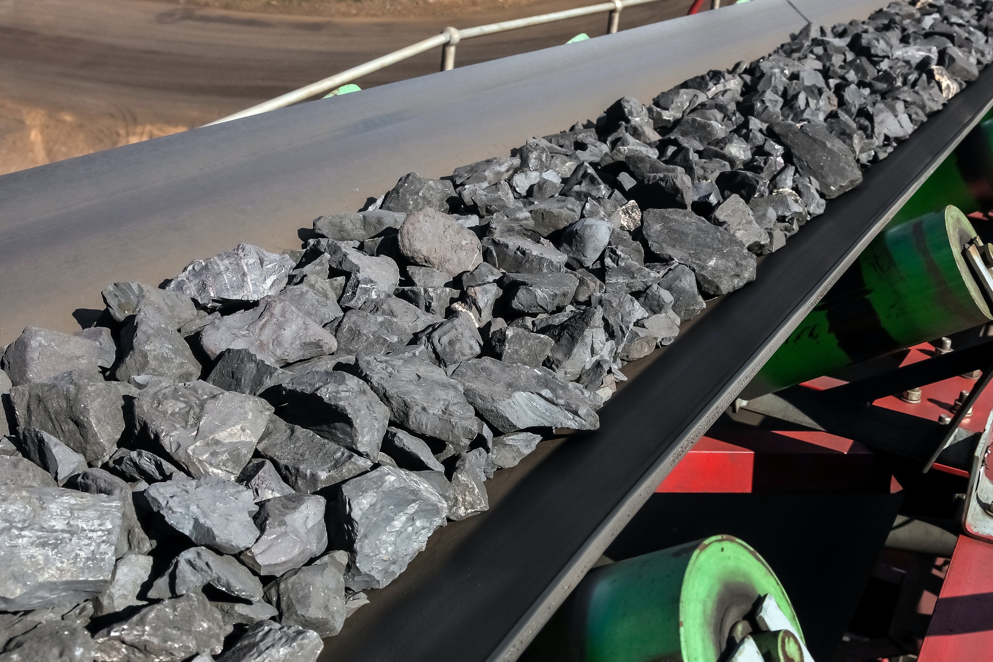 Closeup shot of platinum rock being moved on a conveyor belt