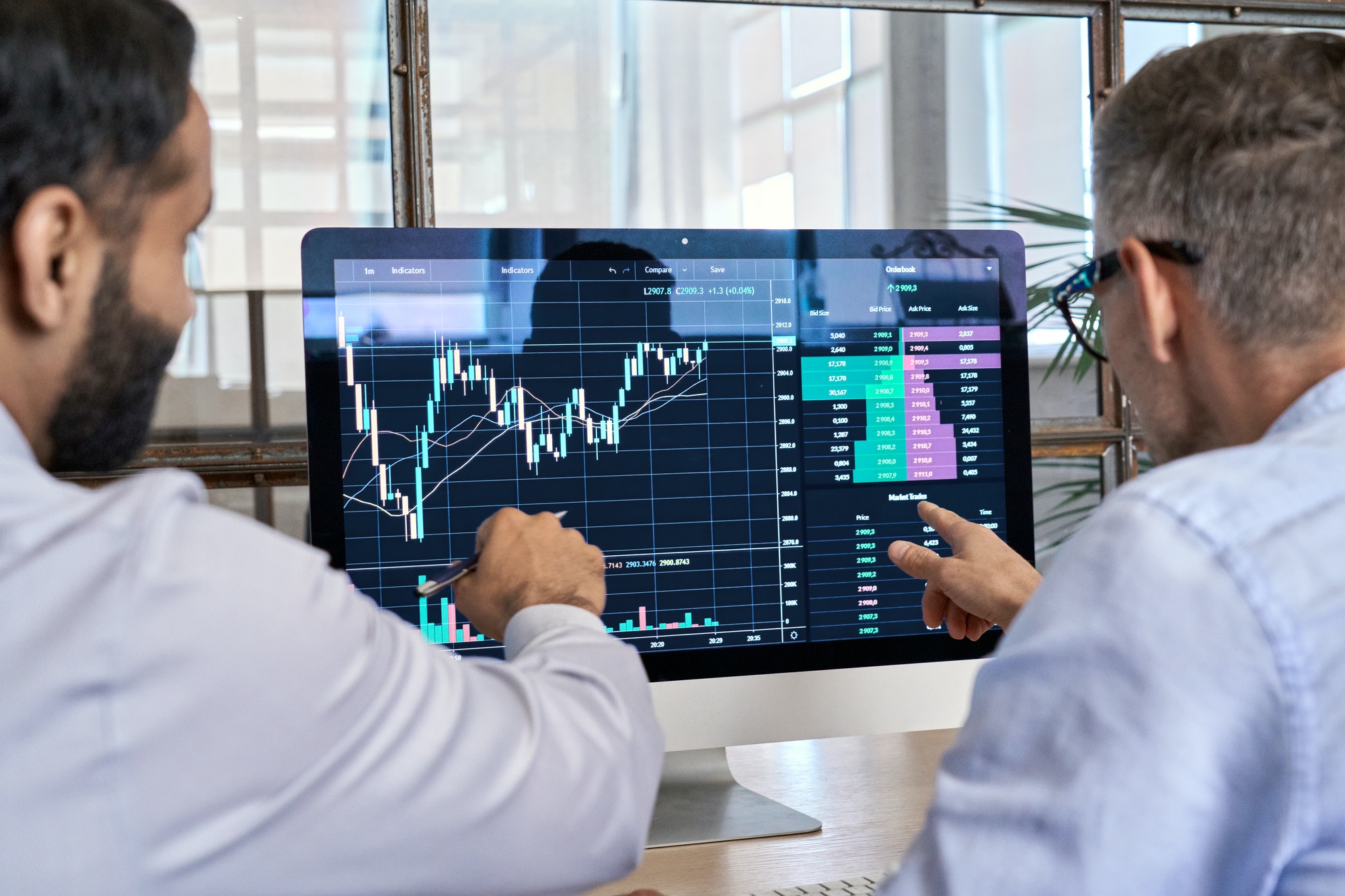 Two traders brokers stock exchange investors analyzing crypto trading charts.
